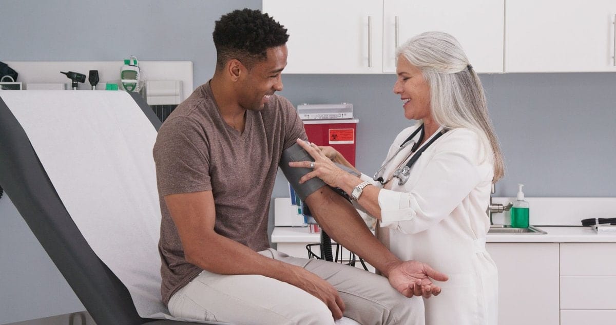 a doctor checking a patient's blood pressure