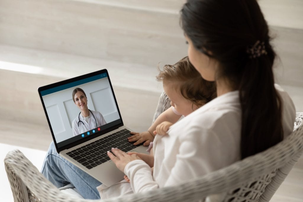 a woman and a baby using a laptop