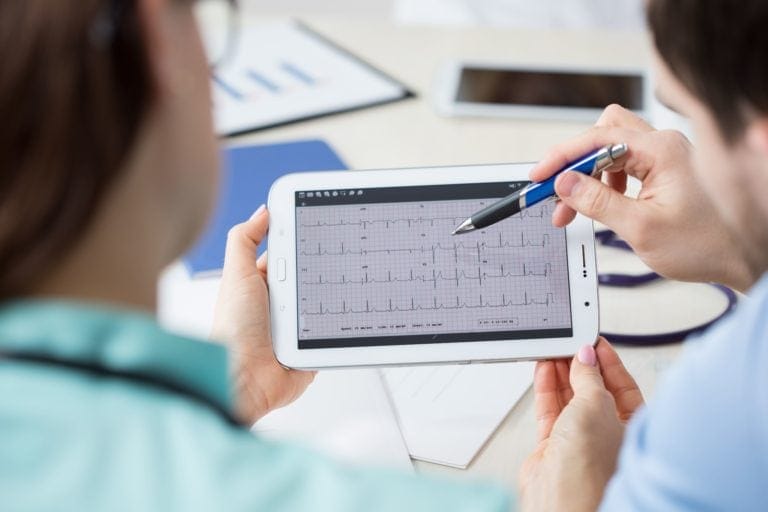 a person holding a tablet EKG (Electrocardiogram)