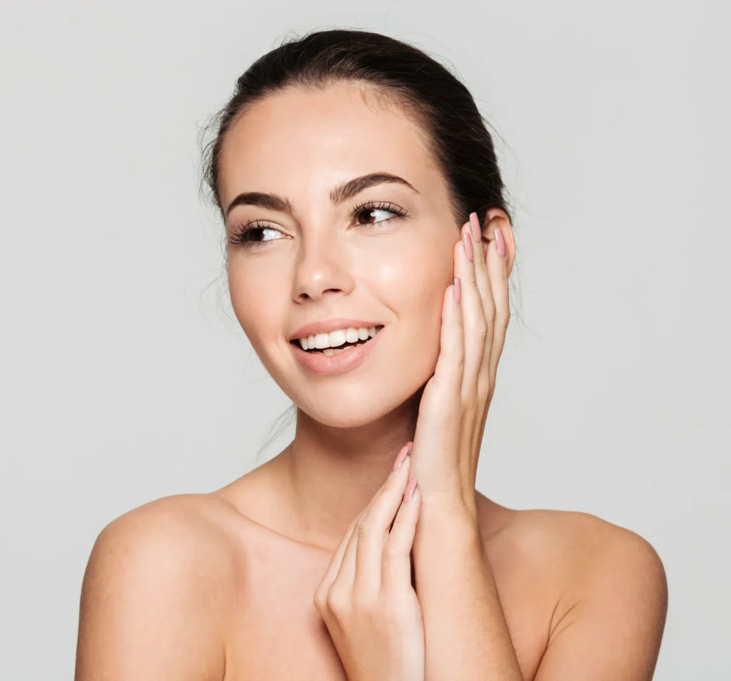 A woman touching her face after Botox Treatment in Webster, TX